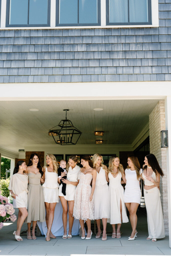 Candid moment of bridesmaids celebrating a proposal on Long Island’s East End, photographed in the Hamptons.