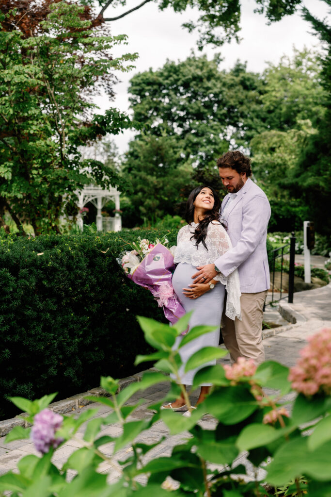 couple standing for maternity photos at westbury manor